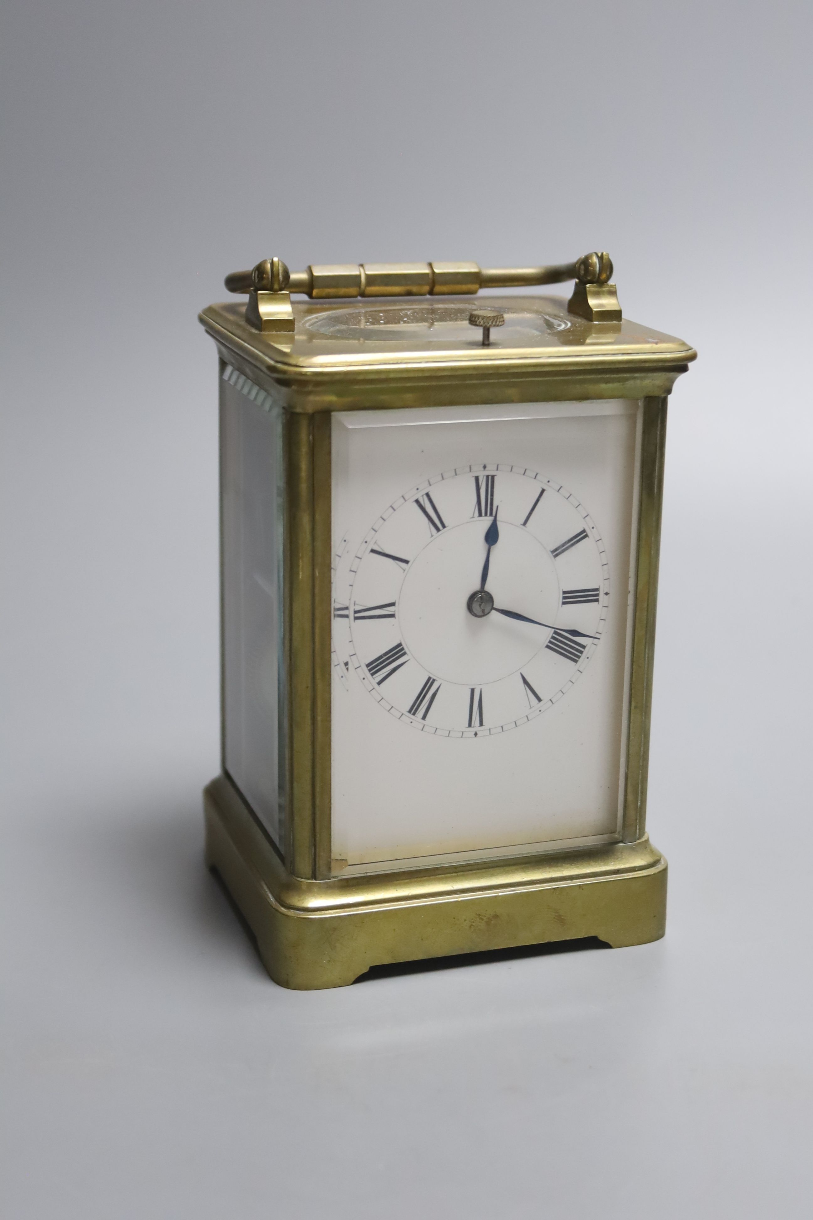 A 19th century brass hour repeating carriage clock, by Henri Jacot, height 15cm with handle down